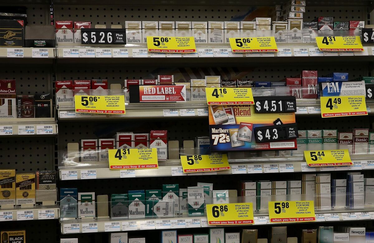 More than two dozen state attorneys general are urging retailers, including Walgreens and Wal-Mart, to stop selling tobacco. The requests comes less than two months after CVS Caremark Corp. said it would stop selling cigarettes, like those shown above in a California store.