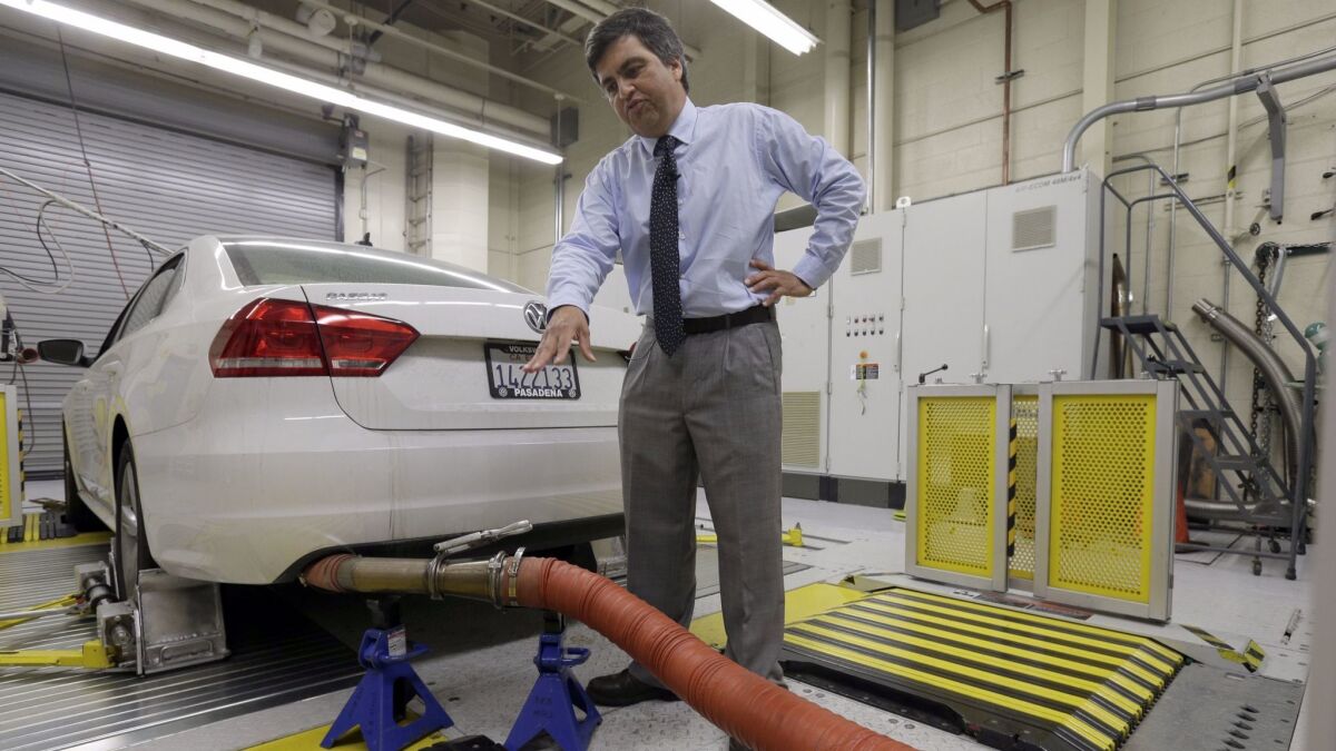 A California Air Resources Board spokesman shows how a 2013 Volkswagen Passat with a diesel engine is evaluated at the emissions test lab in El Monte in 2015.