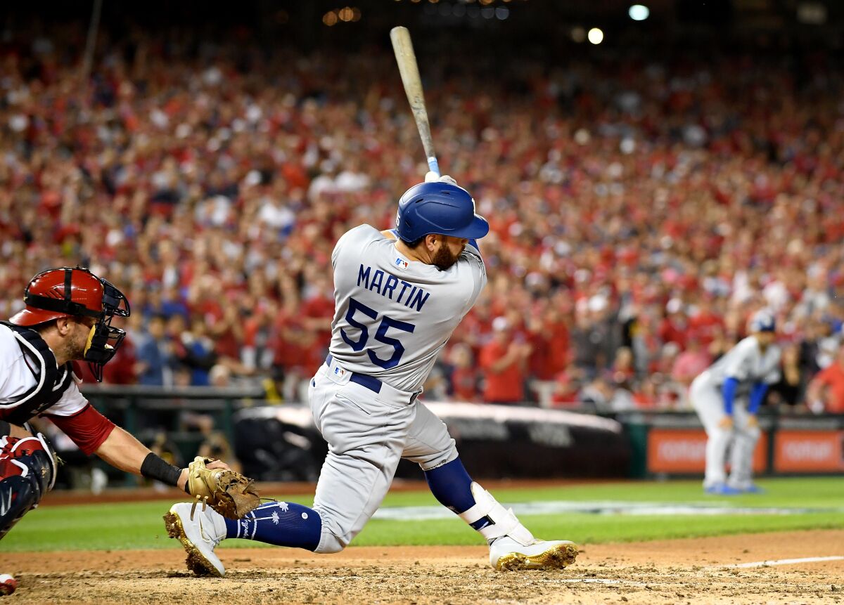 Dodgers catcher Russell Martin hits a two-run double against the Nationals in Game 3 of the NLDS on Sunday.