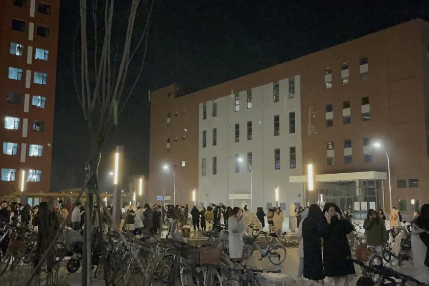 In this photo provided by Wang Xi, students gather outdoor after evacuating from their dormitories at the Lanzhou University Yuzhong campus in Lanzhou in northwestern China's Gansu province Tuesday, Dec. 19, 2023, after an earthquake hit the area. At least 100 were killed in a magnitude 6.2 earthquake in northwestern China, the country's state media reported on Tuesday. (Wang Xi via AP)