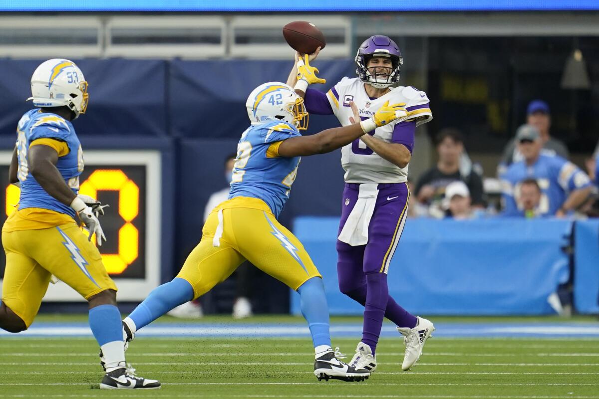 Chargers outside linebacker Uchenna Nwosu deflects a pass by Minnesota Vikings quarterback Kirk Cousins.