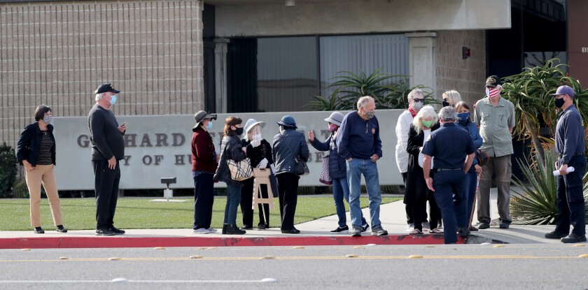 Individuals are lining up for the COVID-19 vaccine at Huntington Beach on Wednesday, January 13, 2021.