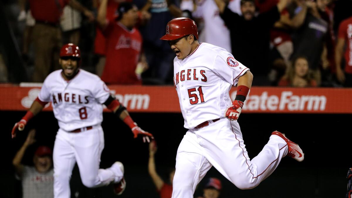Angels pinch-runner Ji-Man Choi scores the winning run after a throwing error by Red Sox first baseman Hanley Ramirez in the ninth inning Thursday night.