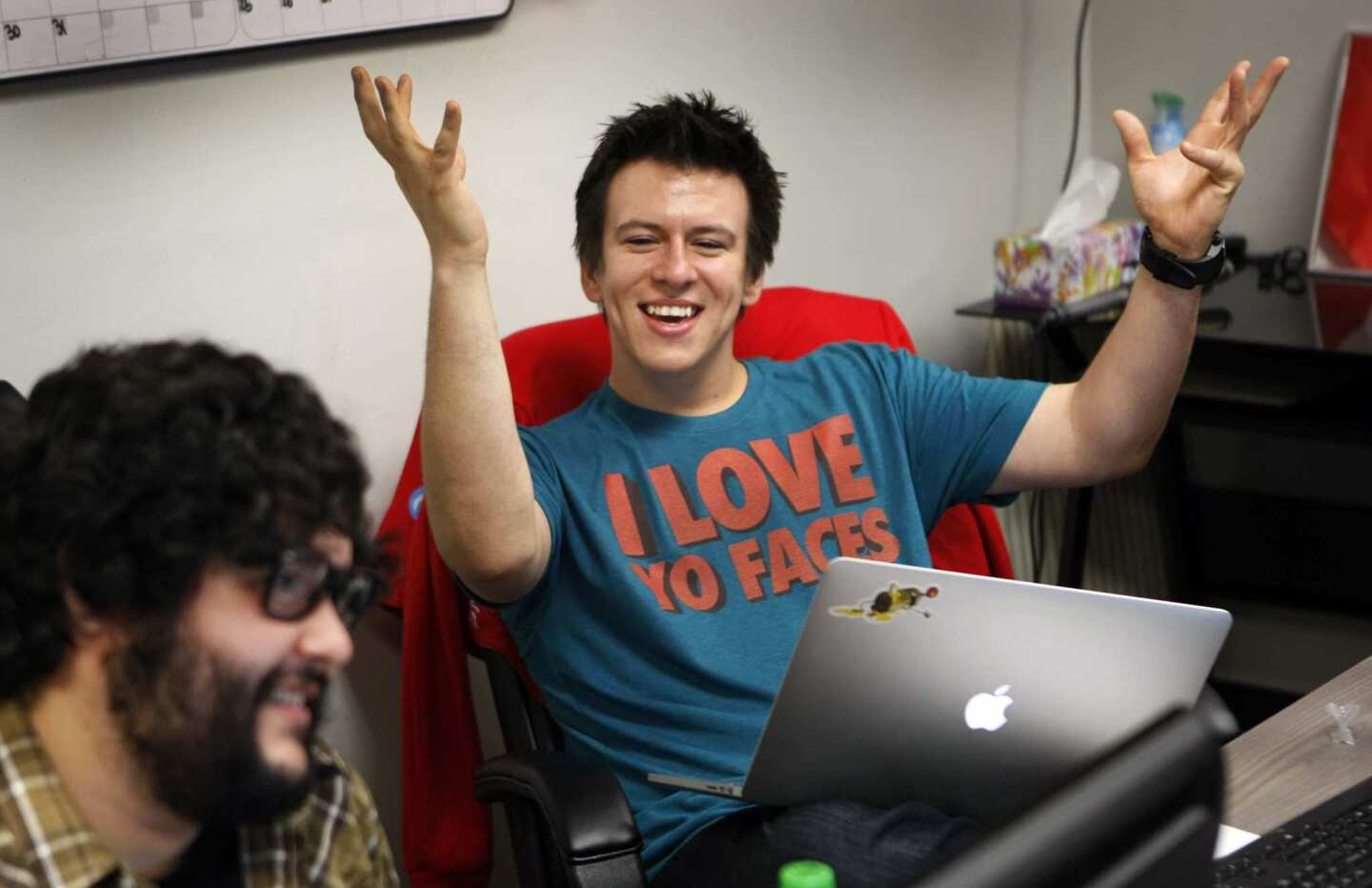 Philip DeFranco, right, laughs with Steve Zaragoza, one of the writers/hosts of "SourceFed" a new YouTube channel show produced by DeFranco.