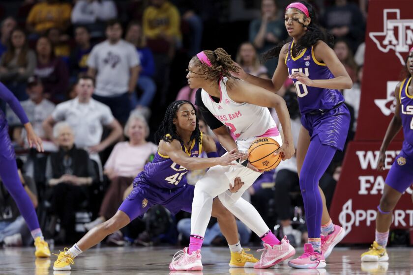 Texas A&M forward Janiah Barker, center, protects the ball as LSU guard Alexis Morris, left, reaches in as forward Angel Reese, right, looks on during the first half of an NCAA college basketball game, Sunday, Feb. 5, 2023, in College Station, Texas. (AP Photo/Michael Wyke)