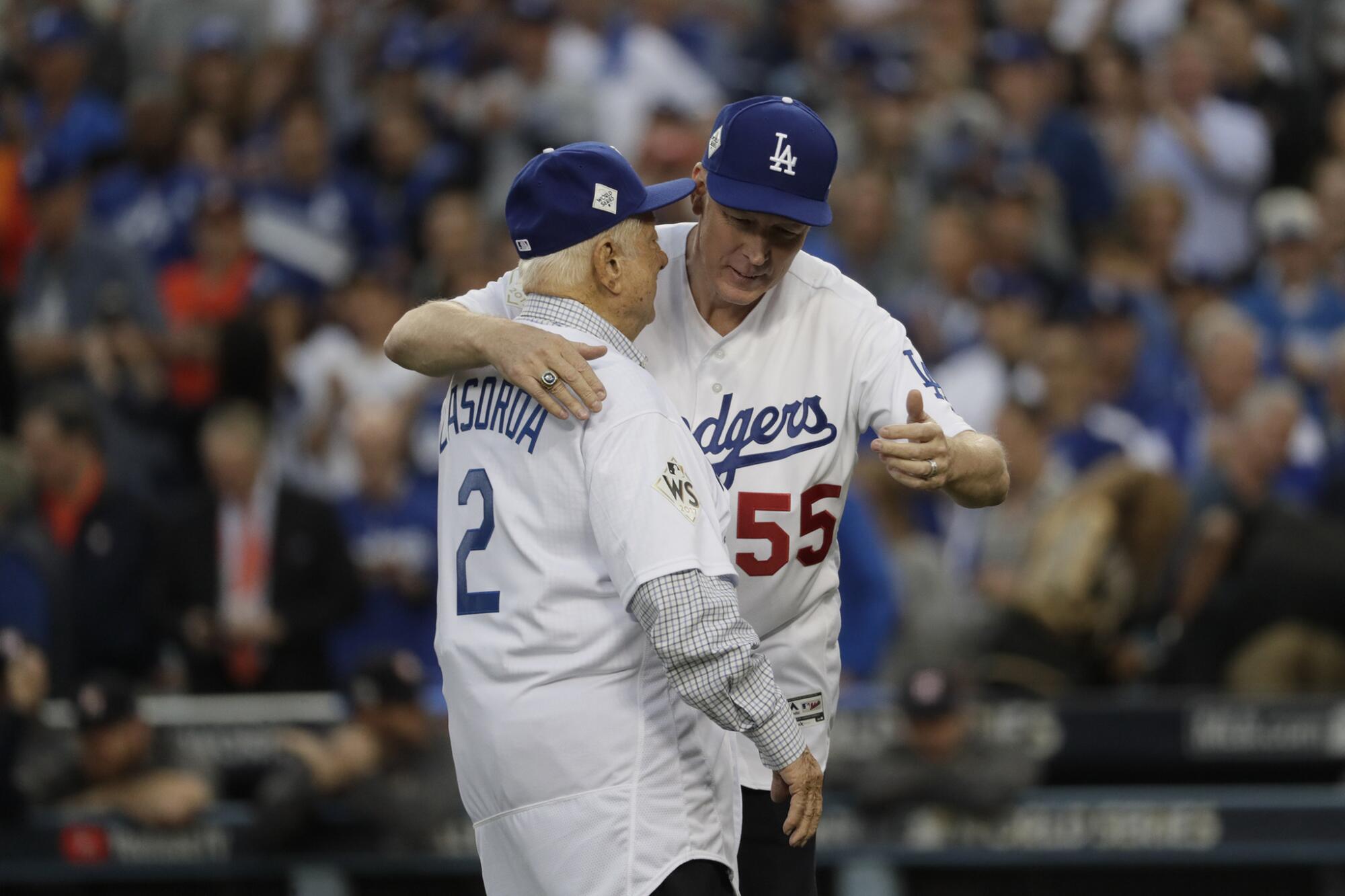 Tommy Lasorda and Orel Hershiser hug after each threw out a ceremonial first pitch before Game 6 of the 2017 World Series