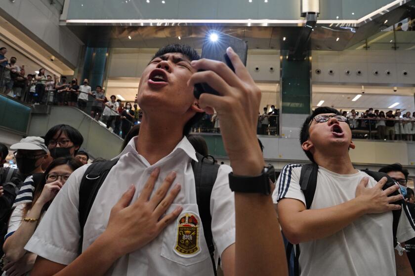FILE - Local residents sing a theme song written by protesters "Glory to Hong Kong" at a shopping mall in Hong Kong on Sept. 11, 2019. An appeals court Wednesday, May 8, 2024 granted the Hong Kong government's request to ban a popular protest song, overturning an earlier ruling and deepening concerns over the erosion of freedoms in the once-freewheeling global financial hub. (AP Photo/Vincent Yu, File)