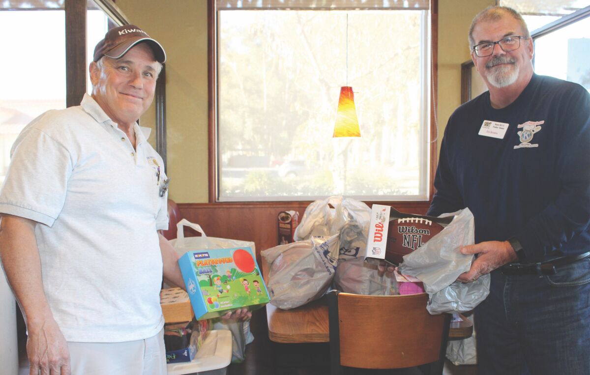 Kiwanis Club of Ramona Immediate Past President Pat Bell, left, and President Chris Bertolero hold Toys for Tots donations.