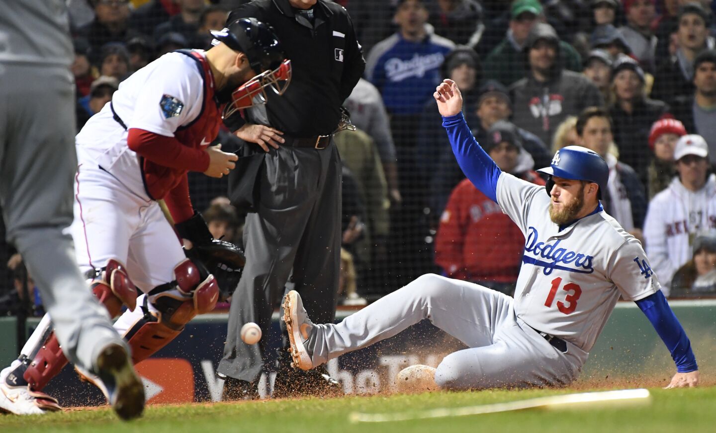 Dodgers Max Muncy scores on a sacrifice fly as Red Sox catcher Sandy Leon bobbles the ball in the 7th inning.