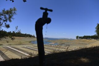 FILE - In this May 22, 2021, file photo, water drips from a faucet near boat docks sitting on dry land at the Browns Ravine Cove area of drought-stricken Folsom Lake in Folsom, Calif. California Gov. Gavin Newsom threatened Monday, May 23, 2022, to impose mandatory, statewide restrictions on water use if people don't start using less on their own as the drought drags on and the hotter summer months approach. (AP Photo/Josh Edelson, File)