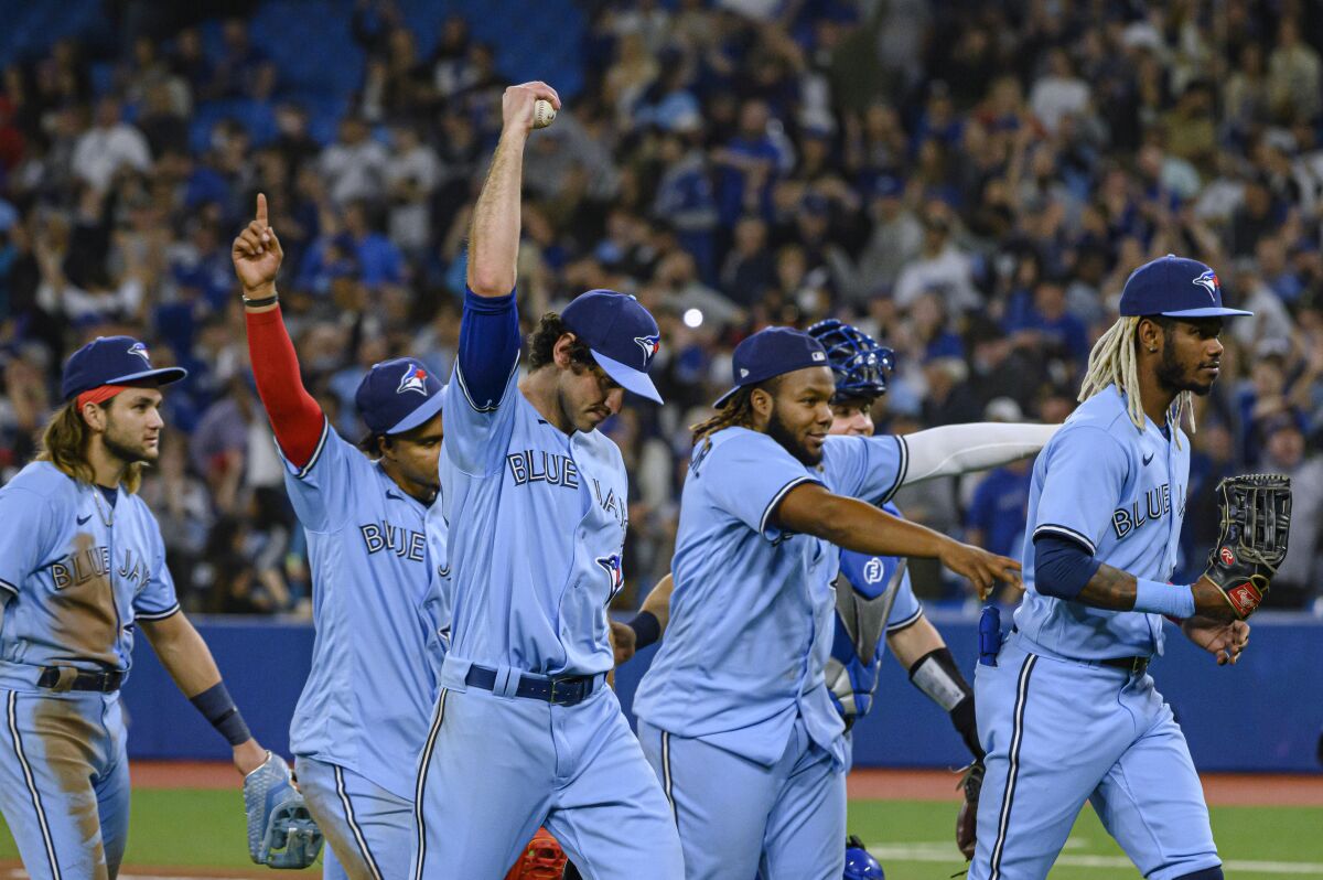 The Toronto Blue Jays celebrate after defeating the New York Yankees in a baseball game Wednesday, May 4, 2022, in Toronto. (Christopher Katsarov/The Canadian Press via AP)