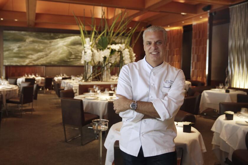 Chef Eric Ripert, poses for photos in the dining room of his restaurant, Le Bernadin. in New York, Tuesday, May 17, 2016. Ripert of Manhattan’s Le Bernardin recalls an uphill climb to culinary greatness in an engrossing new memoir, “32 Yolks.” (AP Photo/Richard Drew)