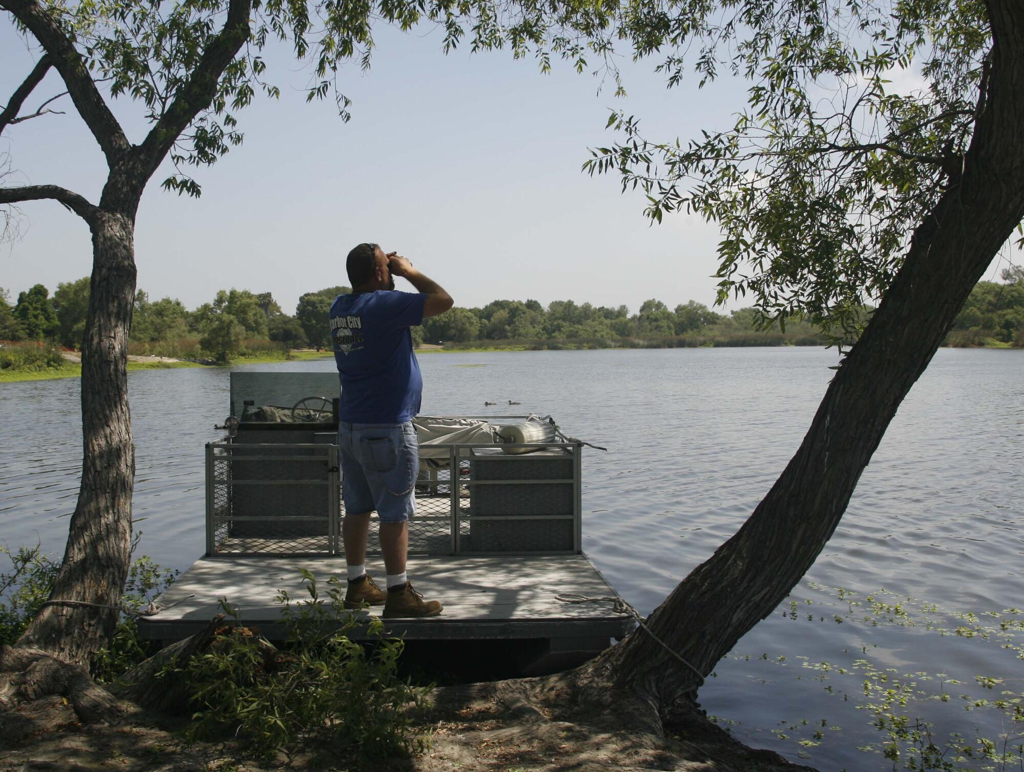 City worker Neal Weeks looks out over Lake Machado