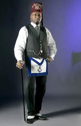 After becoming a Master Mason (the term used for a new member who has completed all levels of study), Zulu went on to become a Scottish Rite Mason and a Shriner  both fraternal organizations that hold Masonic membership as a prerequisite. Here he wears his Shriners fez, his Master Masons apron and his daily wardrobe of French-cuffed shirts, pinstripe trousers, a shawl-collared silk brocade vest and a vintage watch chain circa 1895. More... • Freemasons gain a higher, hipper profile Also in Image: • The Big Deal: Shoe bargains to get lost in • Hey Dodger fans: True Blue tattoo shop, Los Feliz • Bob Mackie reunites with Cher • Cher through the years - dressed by Bob Mackie • Meet the millennial Masons • Stylish Masons through history