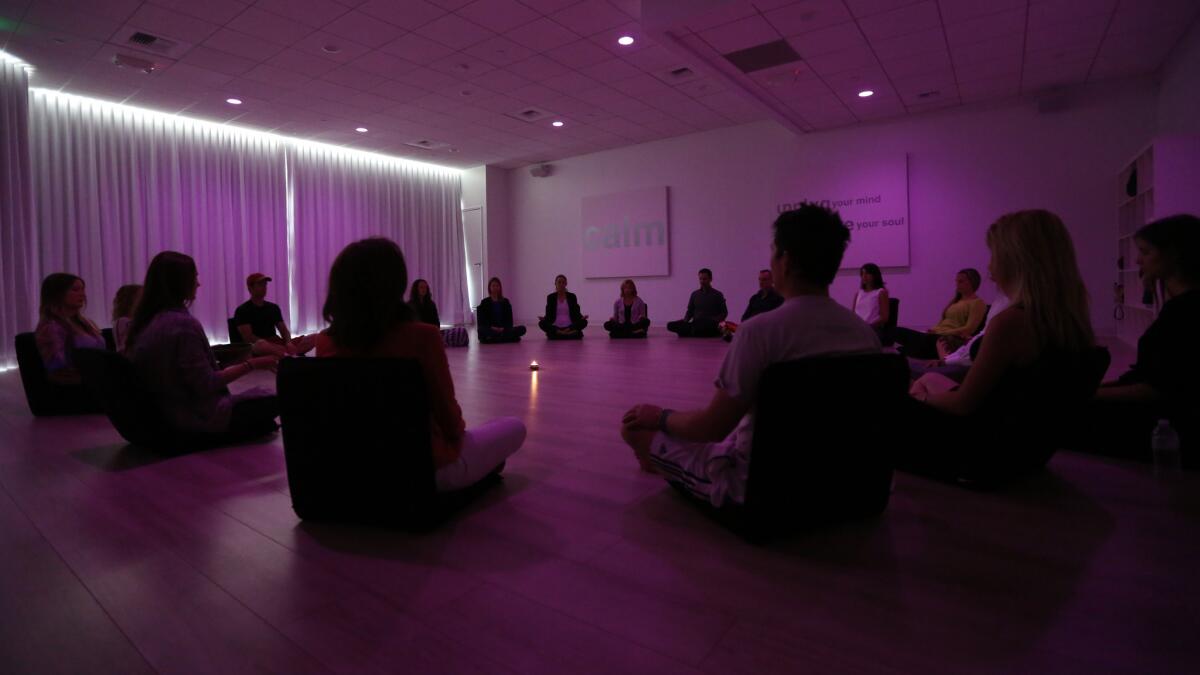 Participants meditate during a class at Unplug, a new meditation studio in Los Angeles, on April 24, 2014.