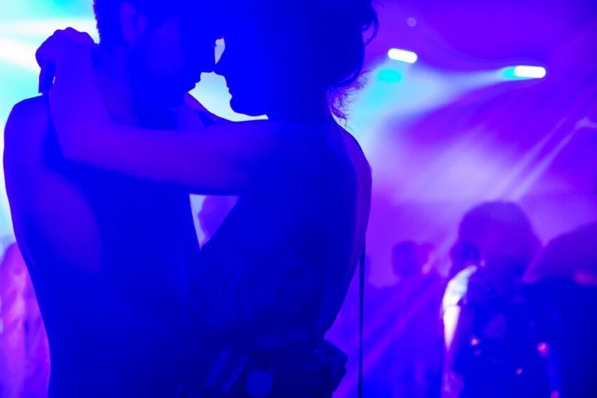 A couple slow-dances at this year's Coachella Valley Music and Arts Festival in Indio. A new study reports that millennials are less promiscuous than their parents, the baby boomers.