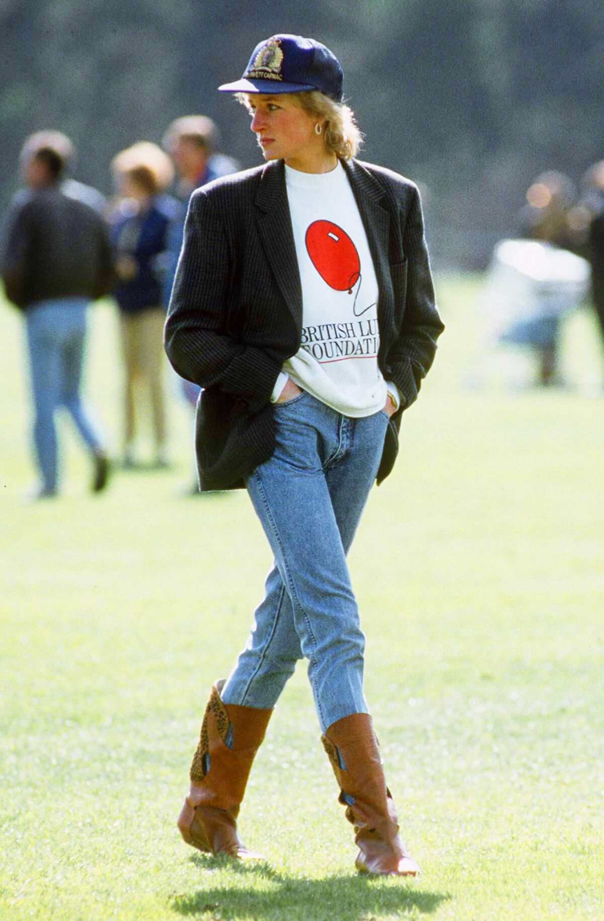 May 1988: At a polo match, Diana displays a carefully constructed casual style in a blazer, sweat shirt and baseball cap.