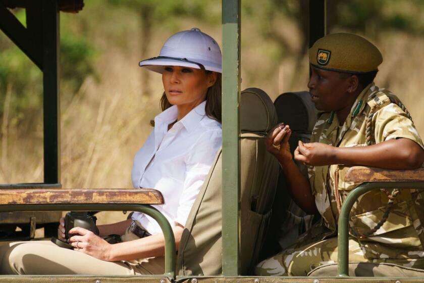 Mandatory Credit: Photo by Carolyn Kaster/AP/REX/Shutterstock (9915343al) Melania Trump, Nelly Palmeris. First lady Melania Trump looks out over Nairobi National Park in Nairobi, Kenya, during a safari guided by Nelly Palmeris, right. Mrs. Trump is visiting Africa on her first big solo international trip Melania Trump Africa, Nairobi, Kenya - 05 Oct 2018