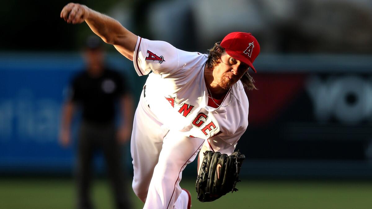 Angels starter Jered Weaver delivers a pitch during the first inning of the team's 5-2 win over the Toronto Blue Jays on Monday. Weaver left the game at the start of the third inning after experiencing tightness in his lower back.
