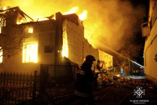 In this photo provided by the Ukrainian Emergency Service, firefighters work on the site of a burning building after a Russian drone attack in Dublyany, Lviv region, Ukraine, Monday, Jan. 1, 2024. (Ukrainian Emergency Service via AP)
