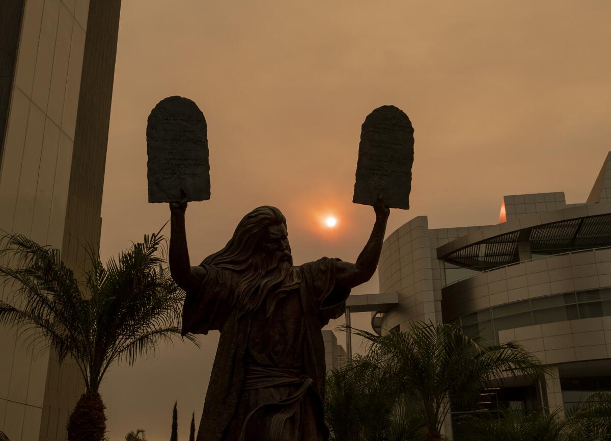 A statue of Moses holding the Ten Commandments is seen at Christ Cathedral in Garden Grove in 2020. 