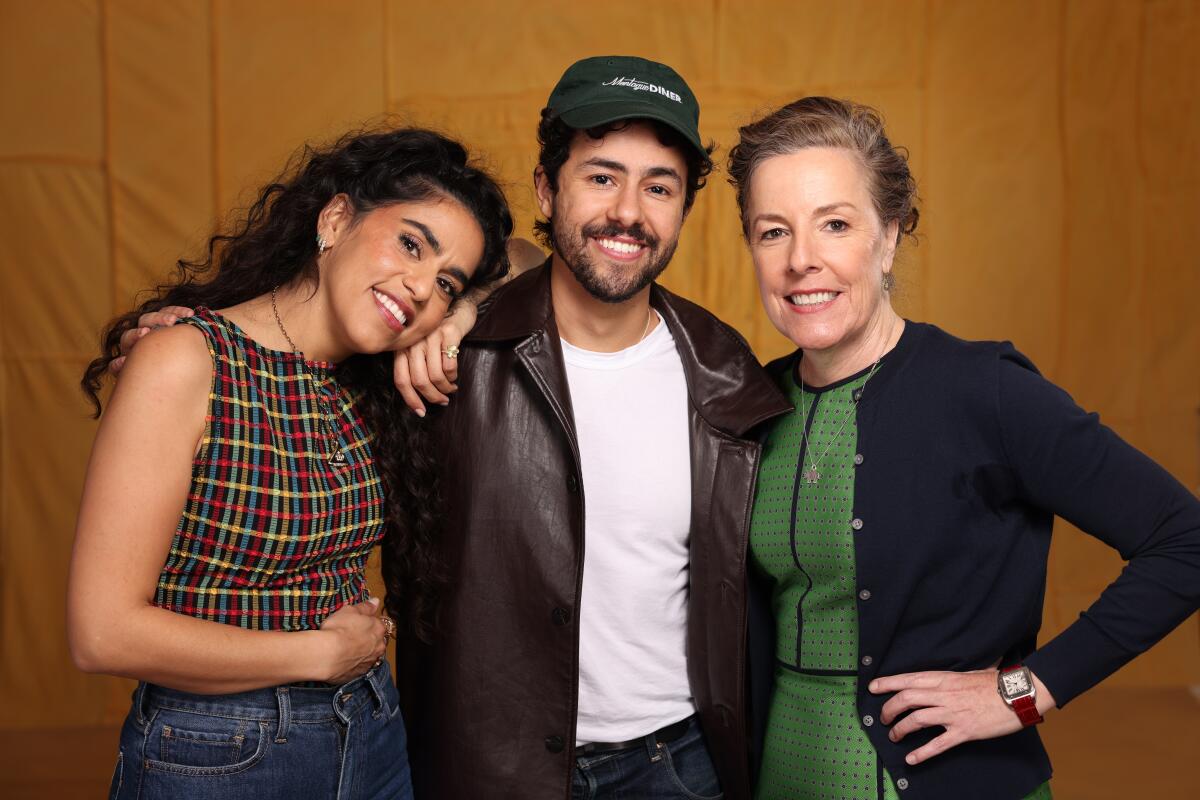 Mona Chalabi, Ramy Youssef and Pam Brady stand in front of an orange background.