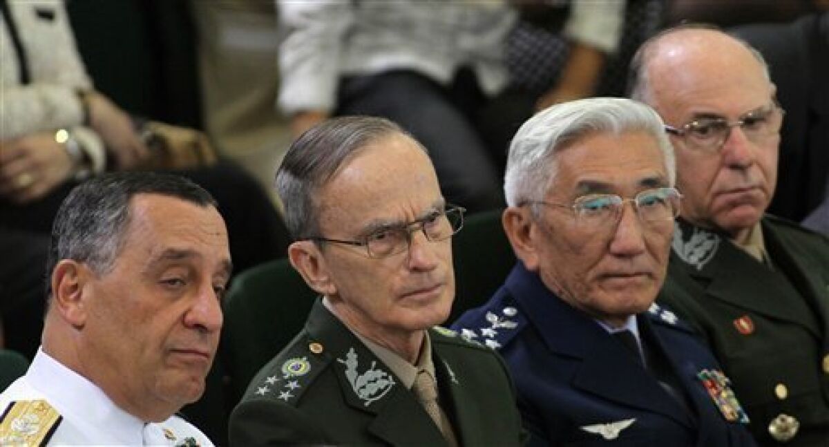 Navy Commander Julio Soares Bueno, left, Commander of the Army Enzo Martins, second from left, Commander of the Air Force Juniti Saito, third from left, and the Commander of the Armed Forces Jose Carlos de Nardi attend a ceremony at which Brazil's President Dilma Rousseff signed a law establishing a truth commission at Planalto presidential palace in Brasilia, Brazil, Friday Nov. 18, 2011. Rousseff established the truth commission to investigate human rights abuses by the military regime that ruled Brazil from 1964 to 1985. However, the commission's recommendations won't result in any prosecutions as long as the country's 1979 amnesty law remains intact. Unlike Argentina, Chile and Uruguay, which also had repressive military regimes, Brazil has never punished military officials accused of human rights abuses. (AP Photo/Eraldo Peres)
