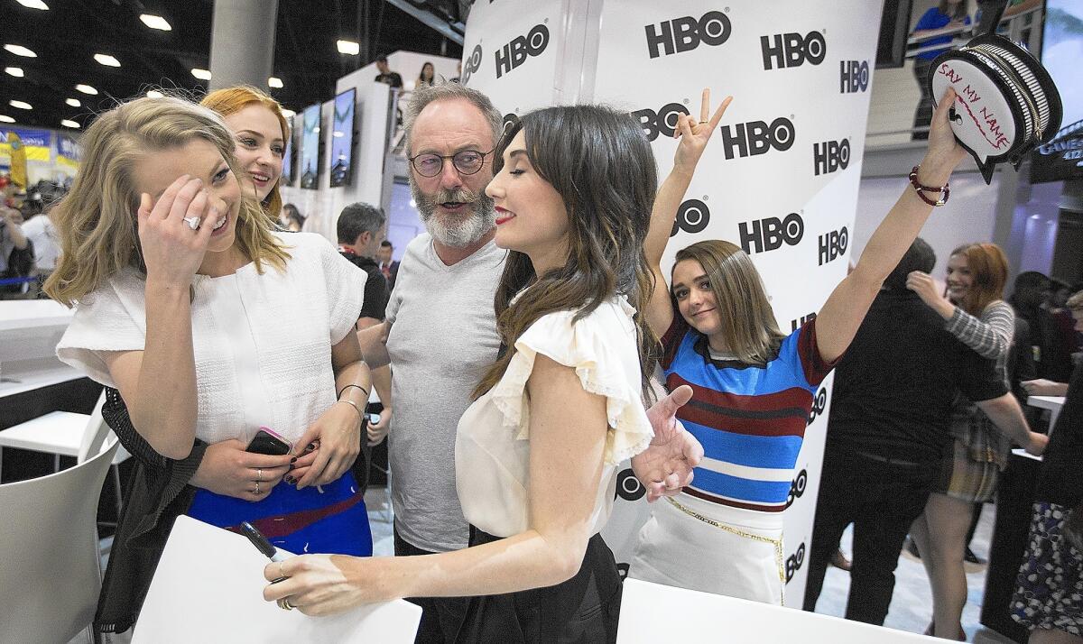 "Game of Thrones" cast members Natalie Dormer, from left, Sophie Turner, Liam Cunningham and Carice van Houten get photobombed by Maisie Williams, far right, at San Diego Comic-Con.