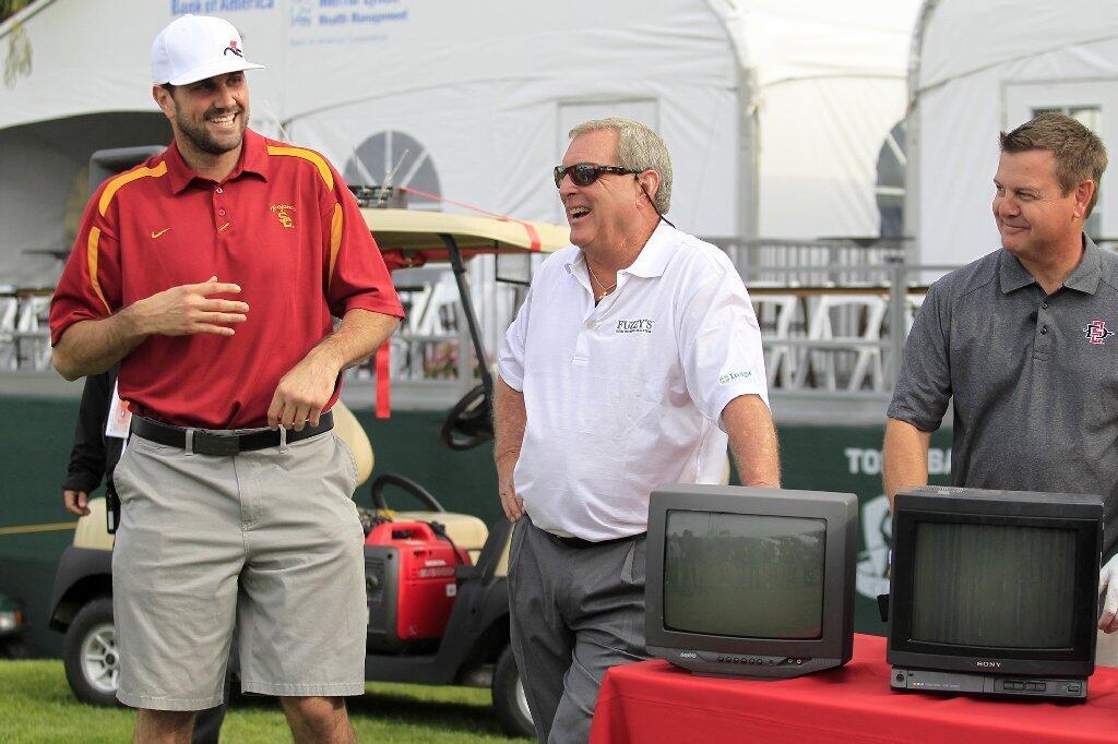 Team USC, from left, NFL quarterback Matt Leinart, Champions Tour player Fuzzy Zoeller and sportscaster John Howard share a laugh as they stand by their gag gifts after losing to Team UCLA in the Toshiba Classic Skills Challenge at Newport Beach Country Club on Tuesday.