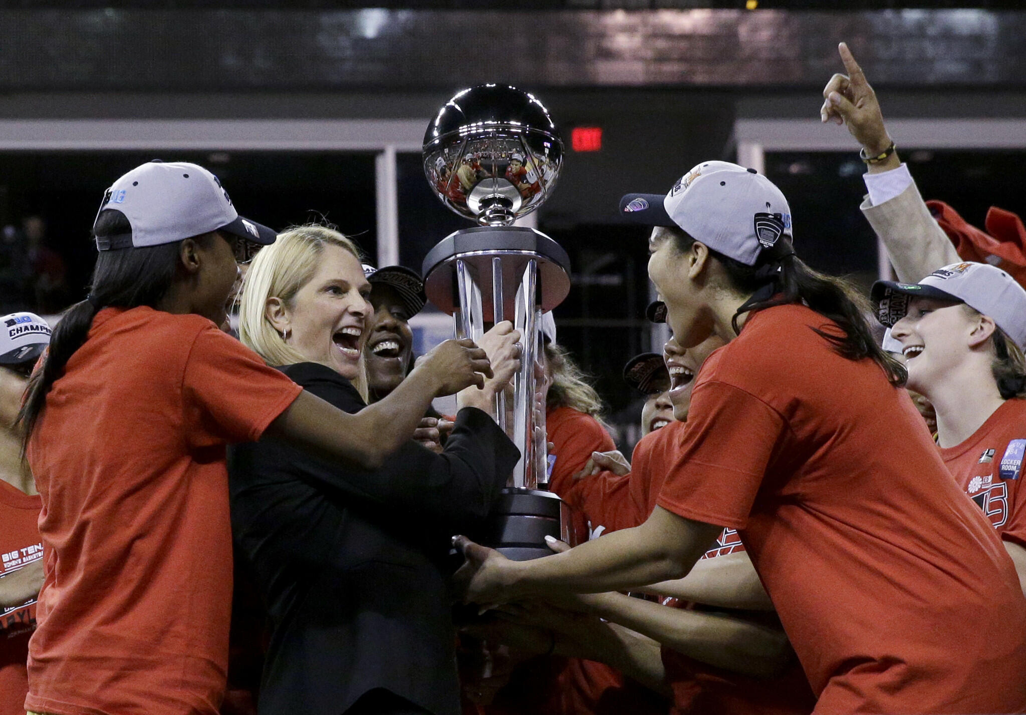 Maryland head coach Brenda Frese celebrates with her players as they hold the championship trophy.
