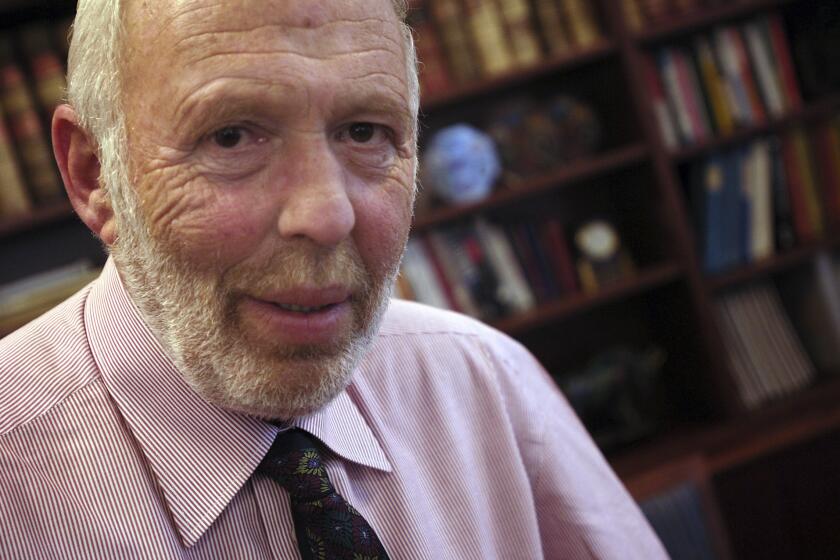 FILE - Jim Simons, a businessman and founder of Math for America, poses at his New York office, Wednesday, Dec. 14, 2005. Simons, a renowned mathematician and pioneering investor who built a fortune on Wall Street and then became one of the nation's biggest philanthropists, died Friday, May 10, 2024. He was 86. (AP Photo/Jason DeCrow, File)