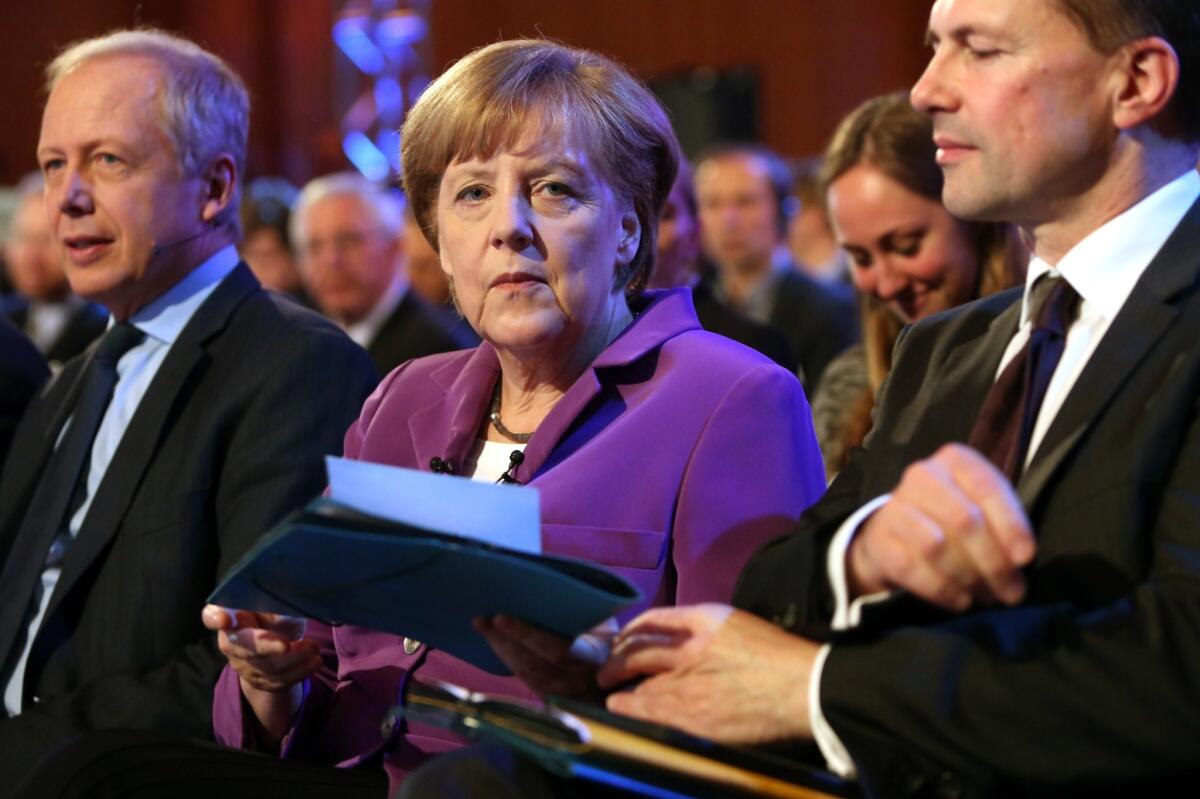 German Chancellor Angela Merkel's spokesman Steffen Seibert, right, told reporters that Merkel has been personally informed about the arrest of a German citizen reported to have spied for the United States.