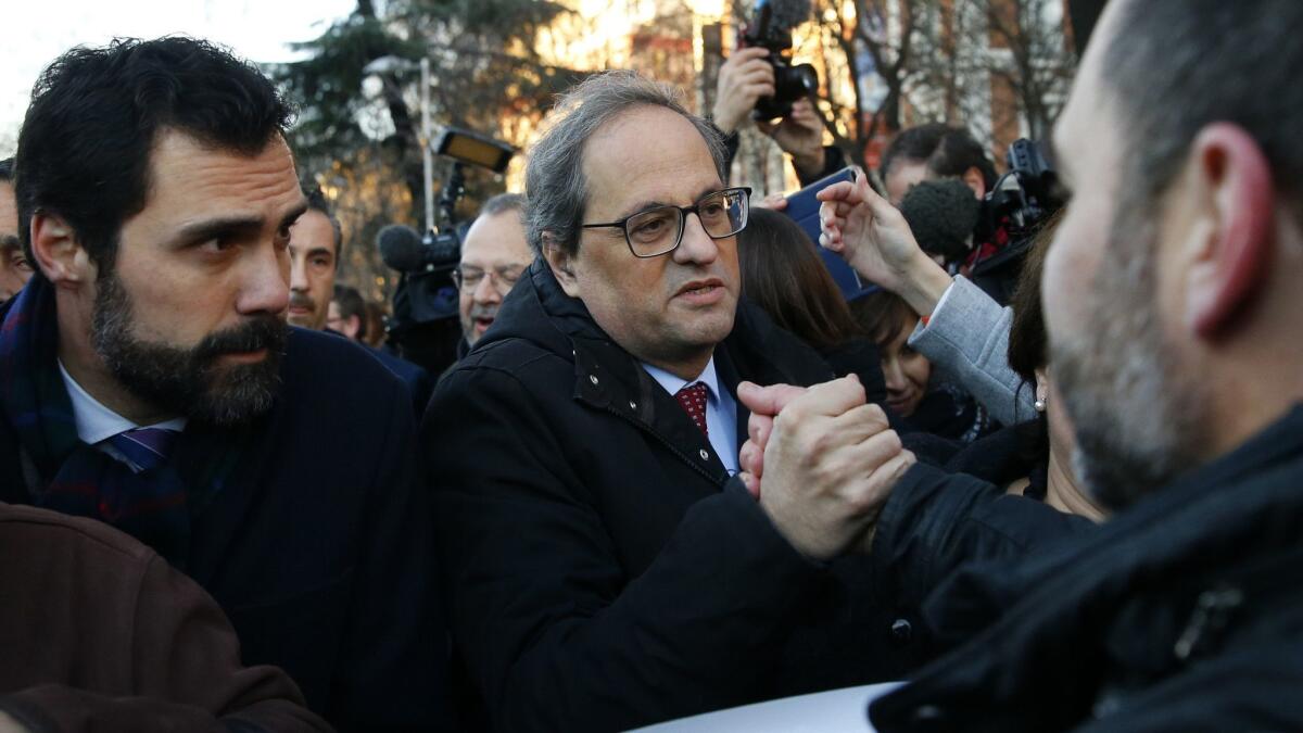 Catalan regional President Quim Torra, right, and the president of the Catalonian Parliament, Roger Torrent, left, arrive at the Spanish Supreme Court in Madrid on Feb. 12 for the trial of a dozen Catalan separatist leaders.