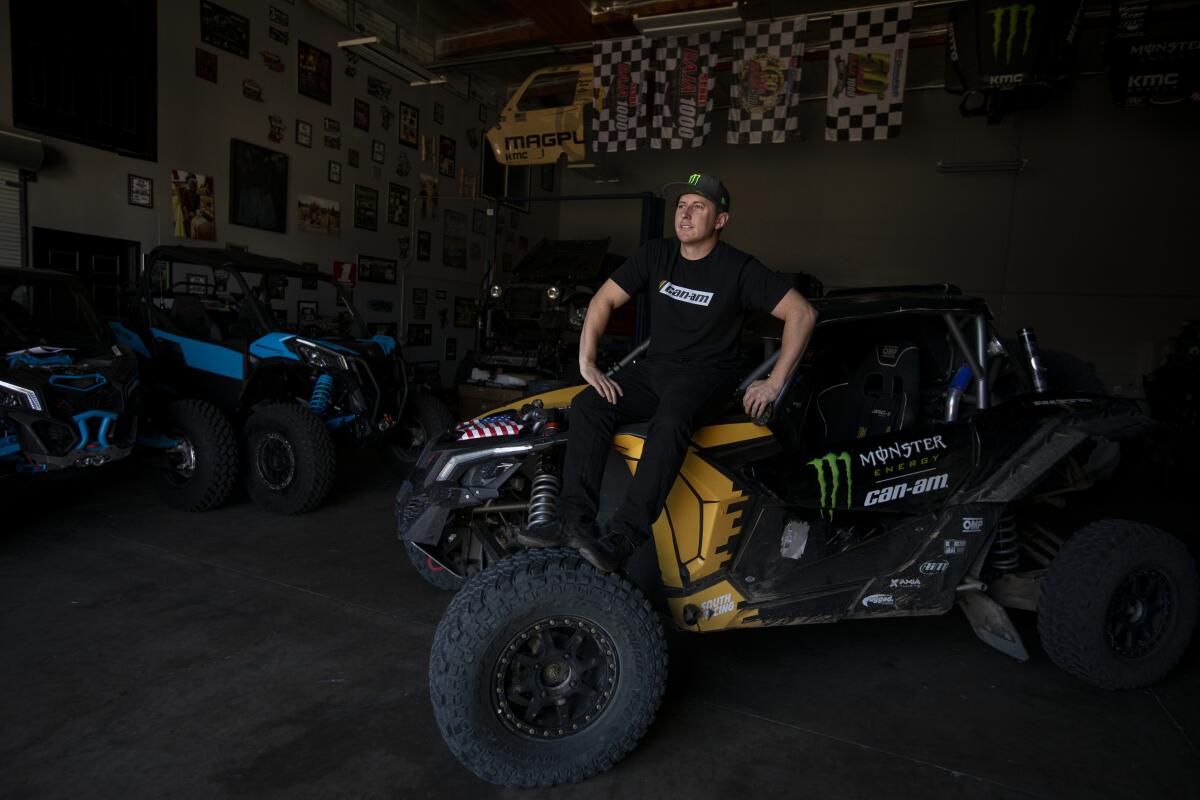 Casey Currie sits on a replica of the vehicle he will be racing in the 2020 Dakar rally raid in Saudi Arabia.