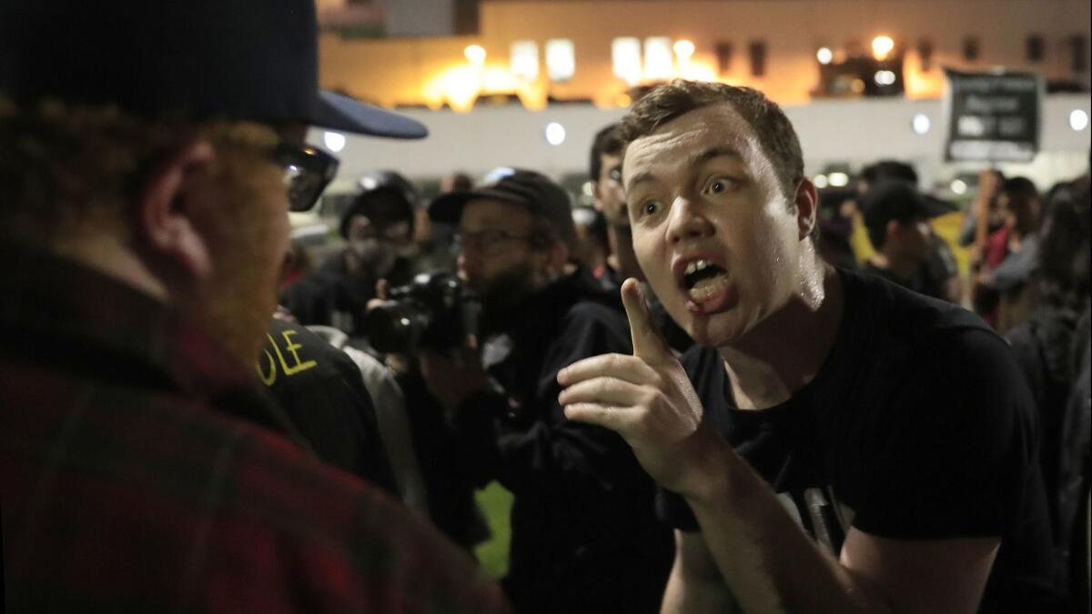 Ian Jameson, of Pasadenans and Altadenans Against Police Violence, shouts at a Trump supporter during a protest against President Trump, who was attending a private event in Beverly Hills .