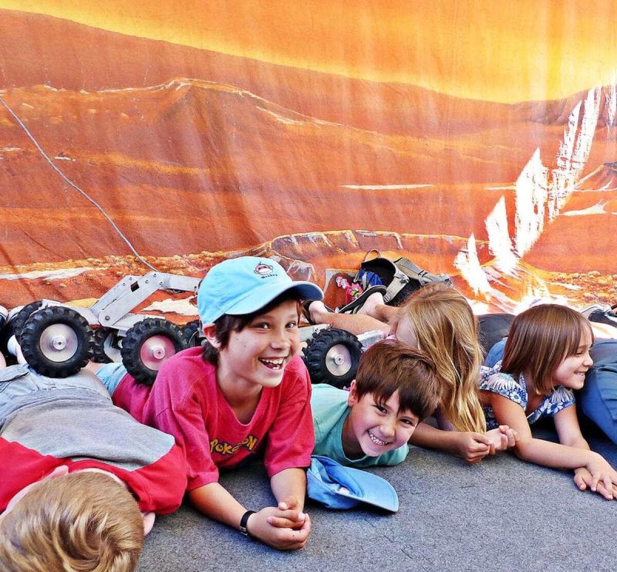 On an open-house day at JPL, kids mimic the "Martian" landscape.