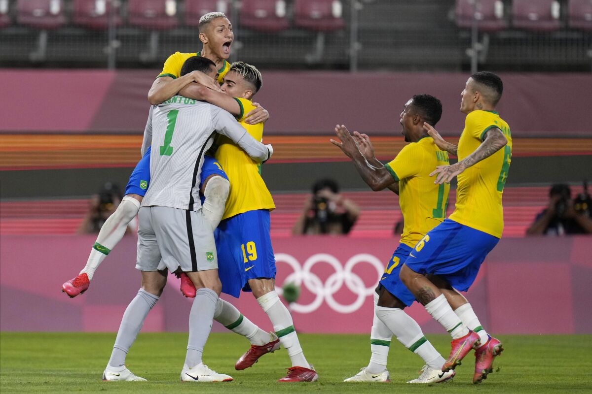 Brazil's players celebrate after defeating Mexico in a penalty shootout in a men's soccer semifinal match at the 2020 Summer Olympics, Tuesday, Aug. 3, 2021, in Kashima, Japan. (AP Photo/Fernando Vergara)