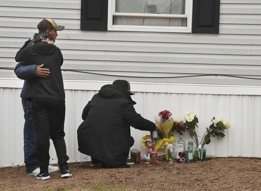 Mourners organize a memorial, Monday, May 10, 2021, outside a mobile home in Colorado Springs, Colo., where a shooting at a party took place a day earlier that killed six people before the gunman took his own life. (Jerilee Bennett/The Gazette via AP)