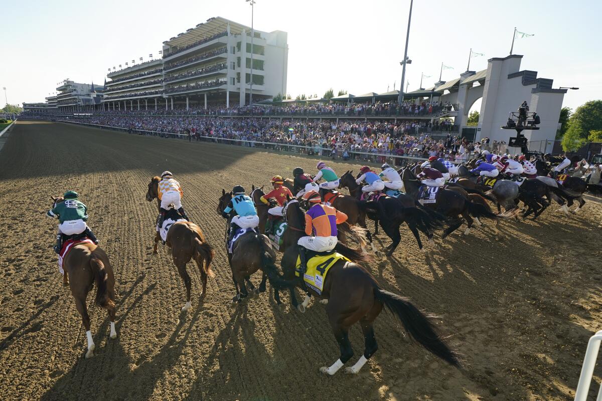 The field of 19 horses and riders bolt out of the starting gate during the 147th running of the Kentucky Derby.