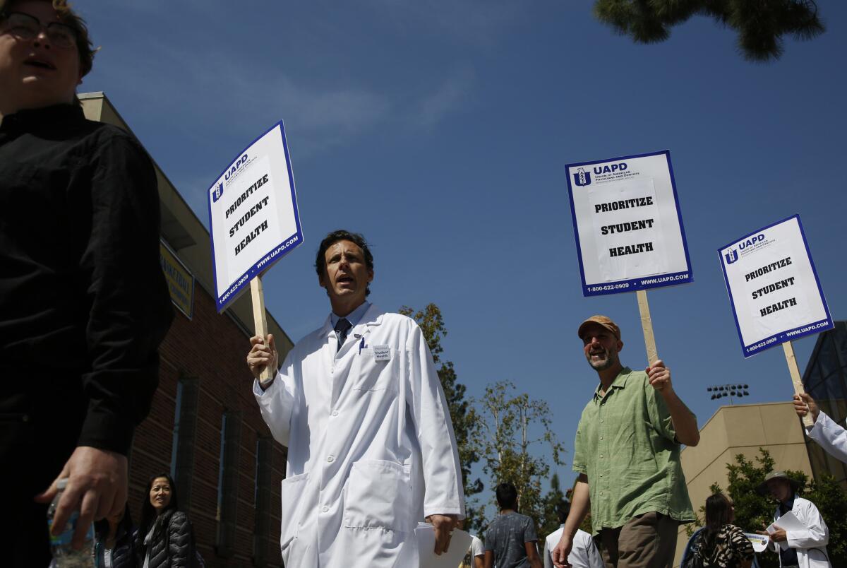 Dr. Charles McDaniel, a psychiatrist at the UCLA student health center, and Jeff Duritz of the Union of American Physicians and Dentists picket at UCLA on April 11.