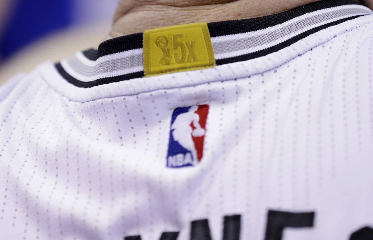 An NBA championship patch is seen on the jersey of San Antonio Spurs center-forward Aron Baynes. The league added championship patches to jerseys this season and could soon add sponsorship ones as well.