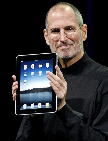 A Jan. 27, 2010, photo shows Apple CEO Steve Jobs with an iPad tablet during a product announcement in San Francisco.