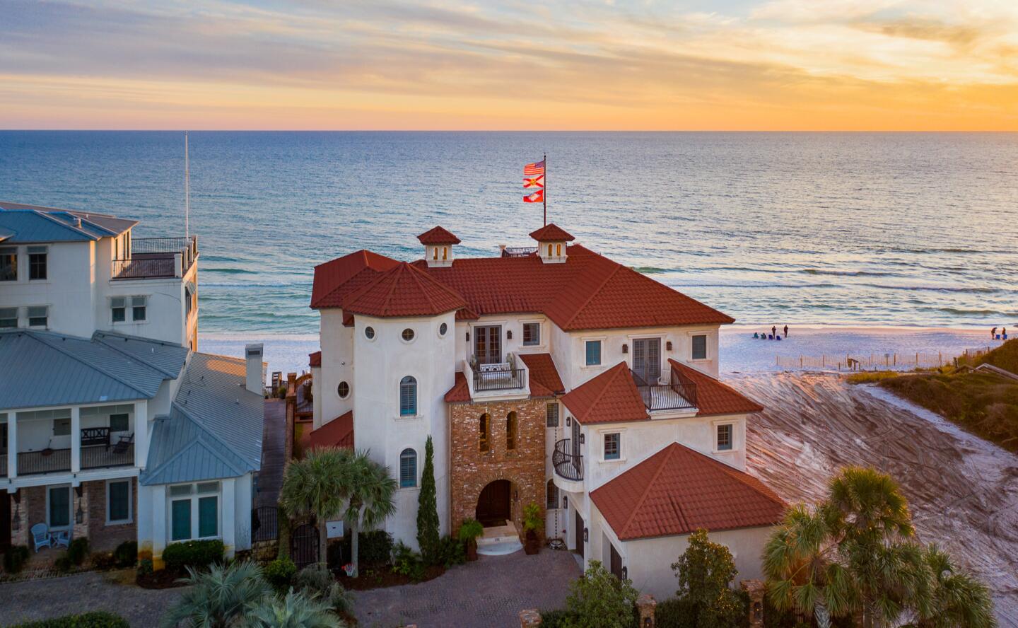 The three-story home includes six bedrooms, nine bathrooms, five balconies and a rooftop deck overlooking the beach.