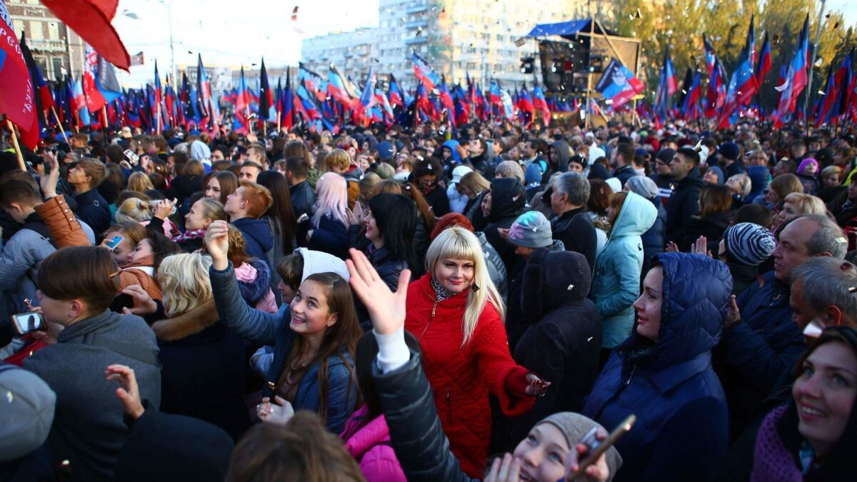 People wait on Nov. 9, 2018, for Denis Pushilin, acting leader of the self-proclaimed Donetsk Republic. Russian President Vladimir Putin on Wednesday signed a decree easing citizenship rules for people living in eastern Ukraine's separatist territories.