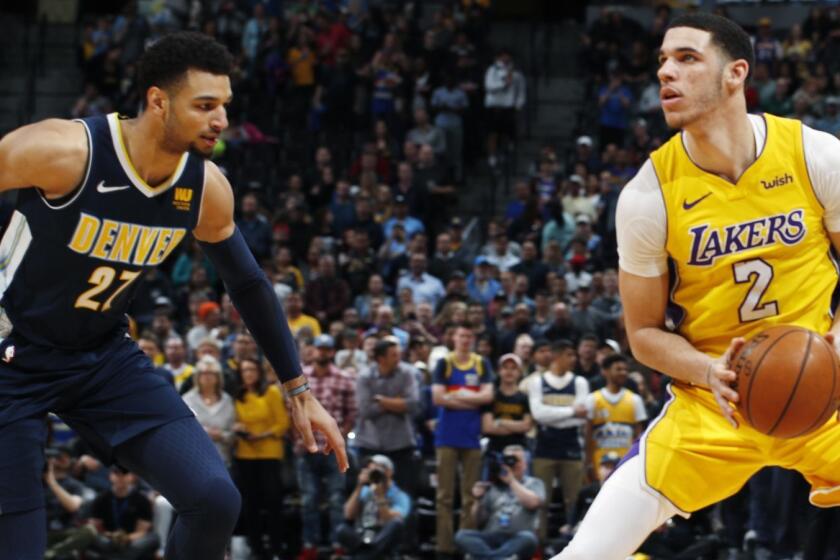 Denver Nuggets guard Jamal Murray (27) and Los Angeles Lakers guard Lonzo Ball (2) in the first half of an NBA basketball game Friday, March 9, 2018, in Denver. (AP Photo/David Zalubowski)