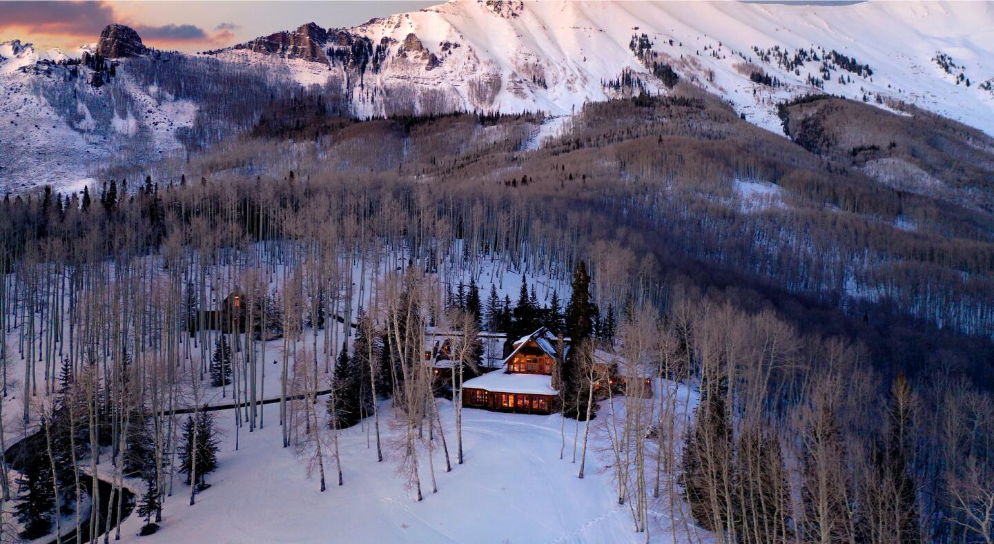 The mountain home shrouded in trees.