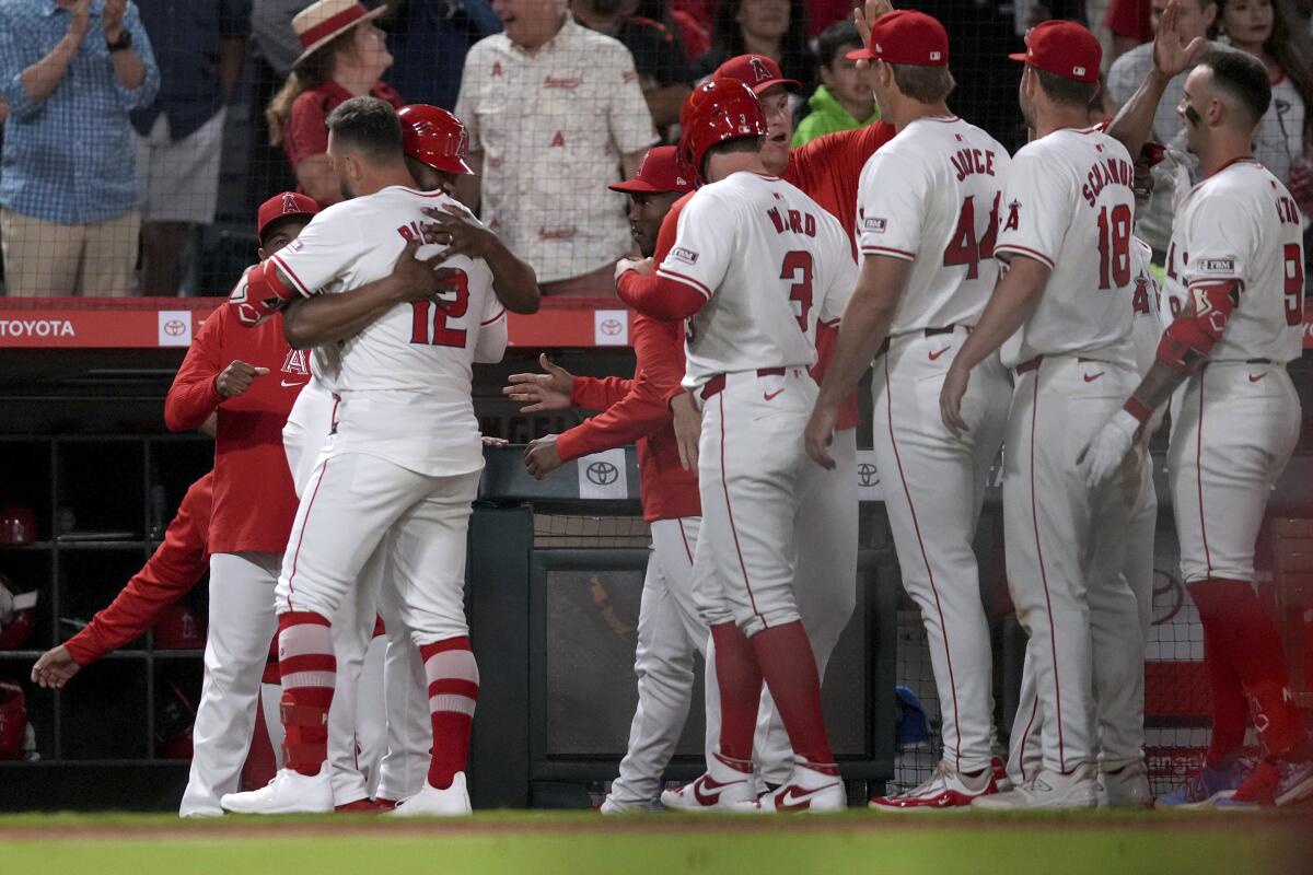 Angels designated hitter Kevin Pillar (12) celebrates with teammates after driving in the winning run.
