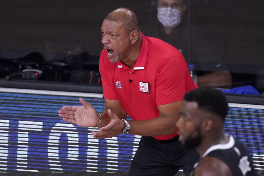 Los Angeles Clippers' Doc Rivers encourages his players during the first half of an NBA conference.