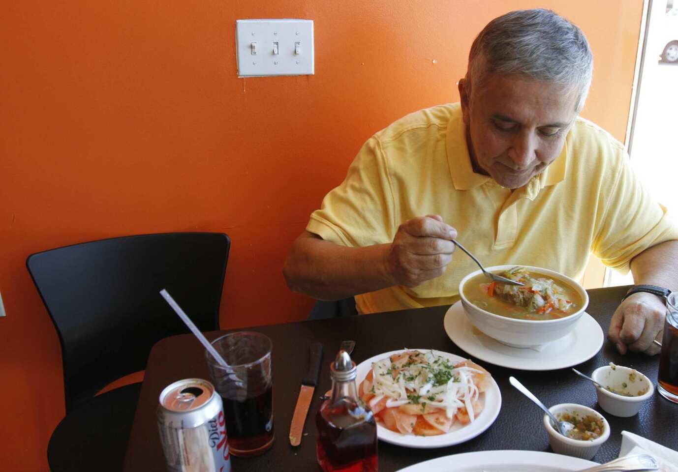 Francisco Aldoney has a bowl of cazuela de vacuno, a traditional Chilean beef soup.
