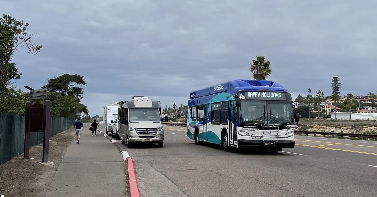 RVs line up along Coast Highway waiting to enter the San Elijo campground.